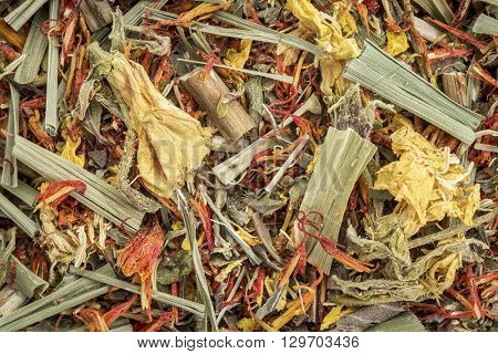 Closeup background of an arthritis  and back pain  herbal tea including lemon balm, safron, primrose and lemon grass