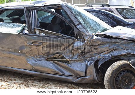 A wrecked car lays in wait after a vicious car accident. 