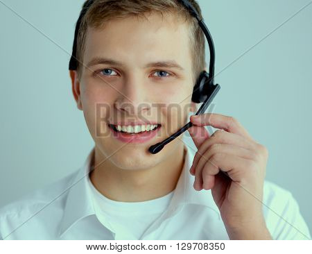 Call center male operator on gray background