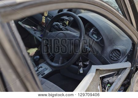 A wrecked car lays in wait after a vicious car accident. 