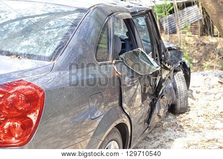 A wrecked car lays in wait after a vicious car accident. 