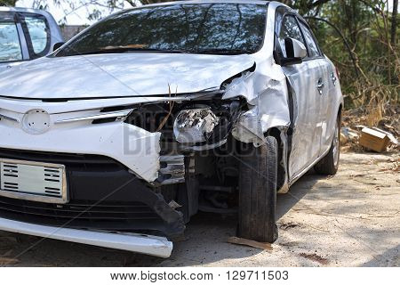 A wrecked car lays in wait after a vicious car accident. 