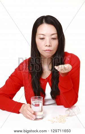 portrait of Japanese woman suffers from melancholy on white background