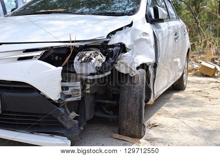 A wrecked car lays in wait after a vicious car accident. 