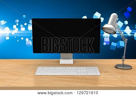 Computer on a desk against futuristic screen with quaders