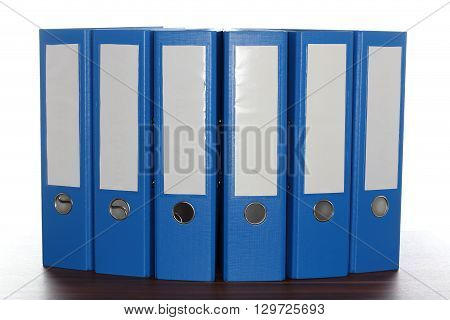 six file folders on a wooden plate