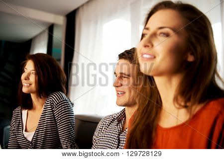 Sisters and brother relaxing at home.