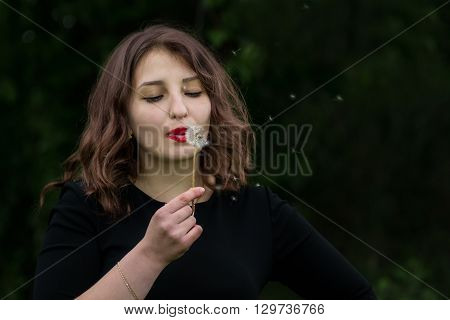 Girl With A Dandelion In The Hand