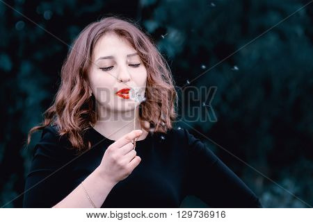 Girl With A Dandelion In The Hand