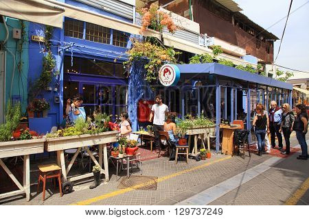 TEL AVIV-YAFO, ISRAEL - APRIL 5, 2016: People at outdoor cafe at popular Jaffa flea market district Tel Aviv, Israel.