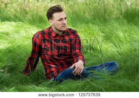 Guy Sitting On The Grass