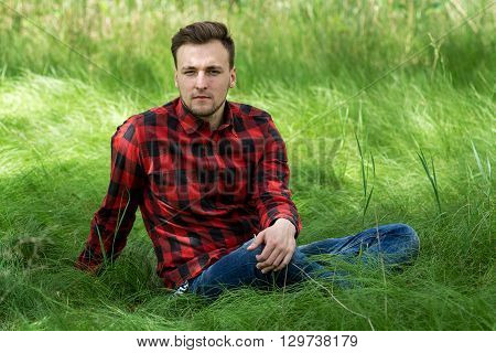 Guy Sitting On The Grass