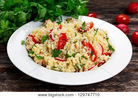 Homemade Fresh Couscous salad with vegetables, in white plate
