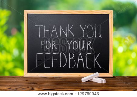 Handwriting Text Thank You For Your Feedback Is Written In Chalkboard On Green Light Background And