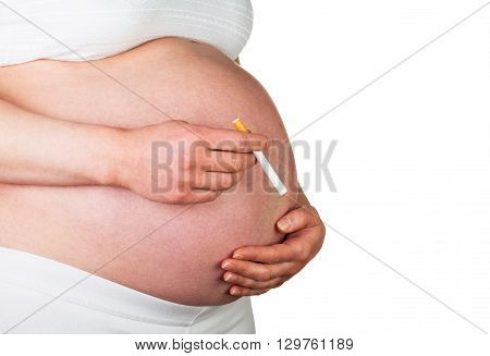 Pregnant woman holding a cigarette isolated on white background.