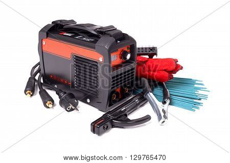 Inverter welding machine, welding equipment, isolated on a white background, leather gloves, welding electrodes, high-voltage wires with clips, set of accessories for arc welding.
