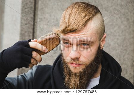 Stylish Man Brushing His Hair