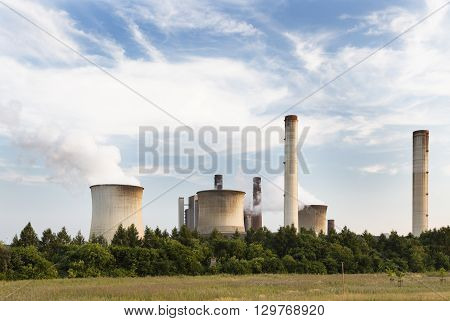 Power Plant Behind Field And Trees