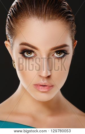 Close up portrait of girl on black background. Evening makeup. Smoky eyes. Hi-end retouch