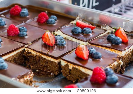 Tasty chocolate pastry with fresh berries. Street food photography on open kitchen event.