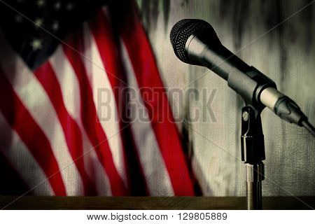 Old american flag and microphone. Microphone beside aged flag. Hear the sounds of past. Journey into the old times.