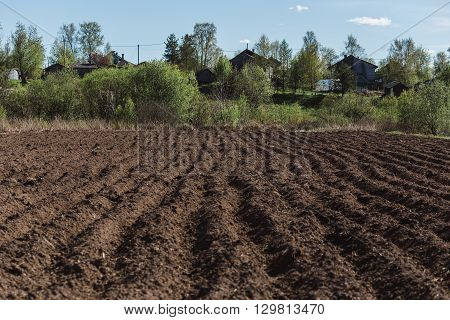 Colours of spring - plouged field ready to sow. Agriculture concept.