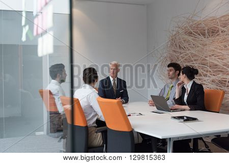 business people group brainstorming on meeting and businessman presenting ideas and projects oon laptop and tablet computer