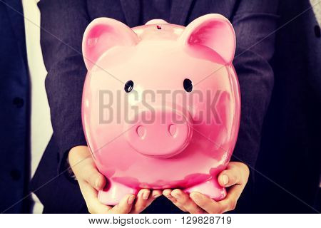 Business team-two men and woman holding piggybank