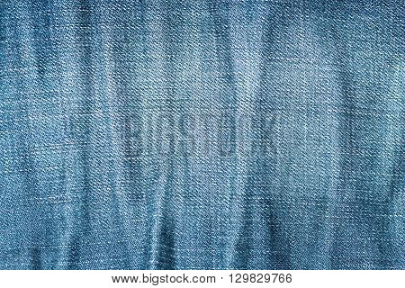 Crumpled blue denim fabric texture for you design