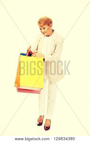Happy business woman holging shopping bags