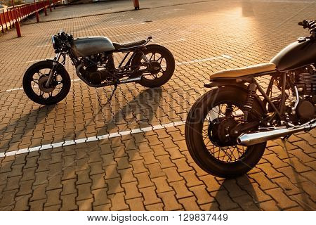 Two Black And Silver Vintage Custom Motorcycles Caferacers