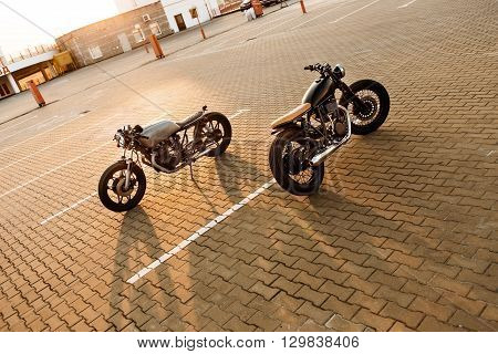 Two Black And Silver Vintage Custom Motorcycles Cafe Racers