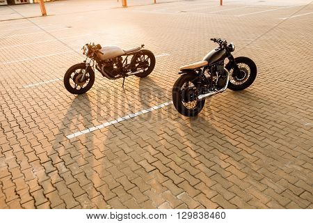 Two Black And Silver Vintage Custom Motorcycles Cafe Racers