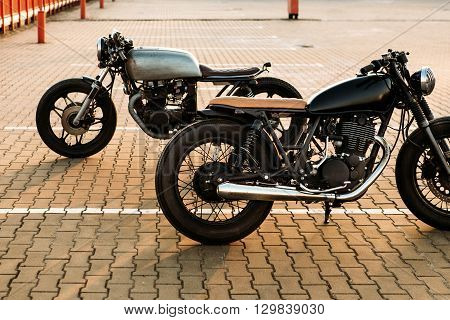 Two Black And Silver Vintage Custom Motorcycles Cafe Racers
