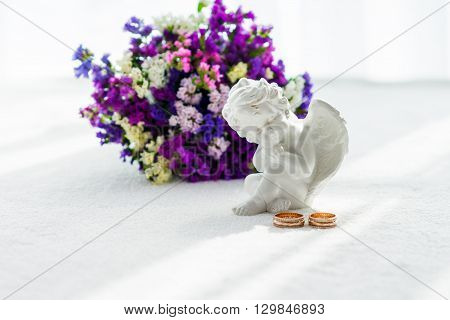Wedding bouquet, wedding rings, angel on a white background
