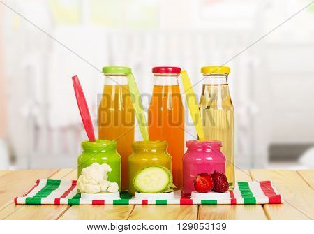Jars and bottles of baby puree juice isolated on white background.