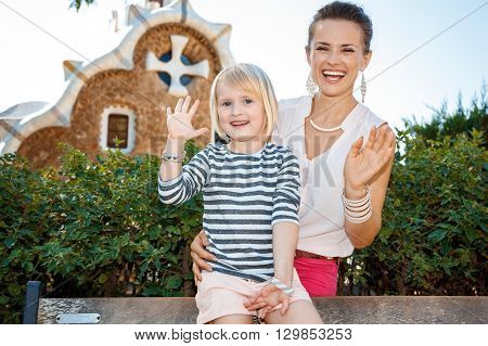 Happy Mother And Child Handwaving In Park Guell, Barcelona