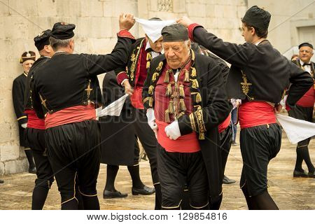 Perast Montenegro - May 15 2016: Shooting the Kokot (rooster) celebration. Celebrates the liberation of Perast from Turkish in 1654. Theatrical performance on a city street. Dance with hankerchief.