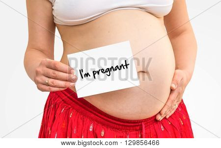 Pregnant woman with inscription: I'm pregnant on her belly