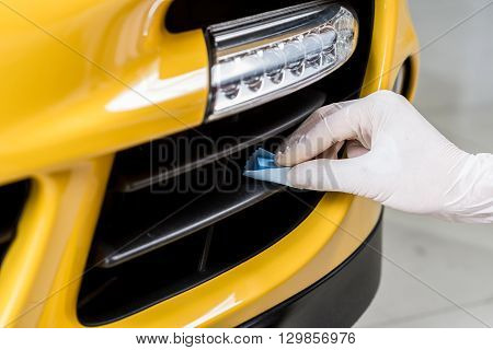 Car detailing series : Closeup of hand coating plastic part