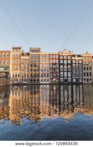 AMSTERDAM NETHERLANDS - 16TH FEBRUARY 2016: Old Buildings along the Damrak in Amsterdam during the day.