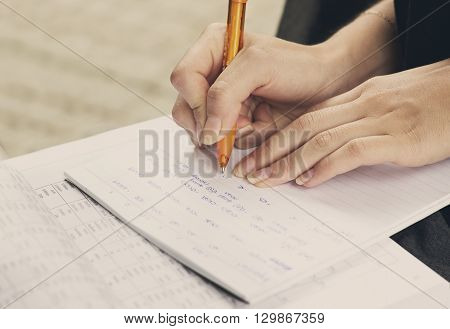 Young girl and education closeup of hands of student doing exercise for universitet exam.
