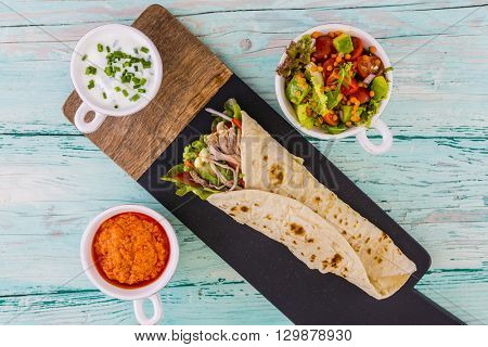 Tortilla with pulled pork, fresh vegetables