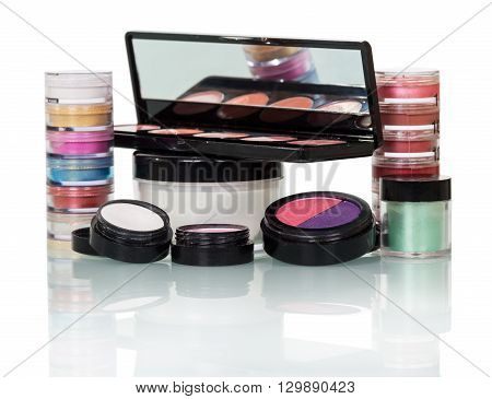 Set of professional cosmetics: lip gloss, eye shadow and blusher isolated on white background.