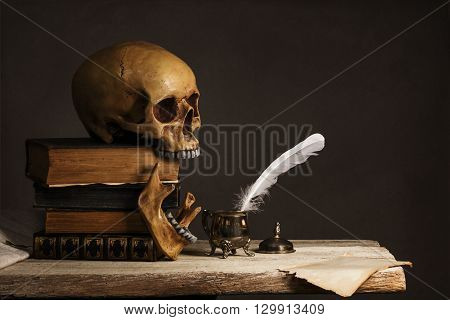 Skull on old Book with empty Page Feather and Inkpot