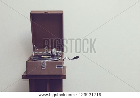 Old retro portable gramophone isolated vintage style toned with empty space