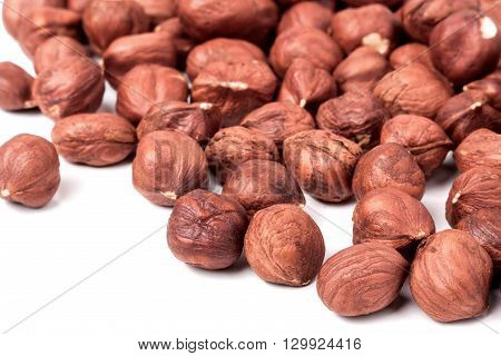 peeled hazelnuts isolated on white background macro.