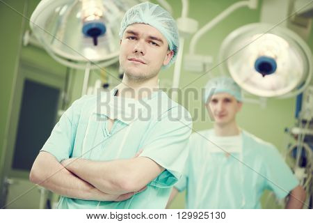 male cardiac surgeon at child cardiosurgery operating room