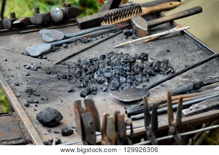 Blacksmith working on metal medieval fire iron hammer work