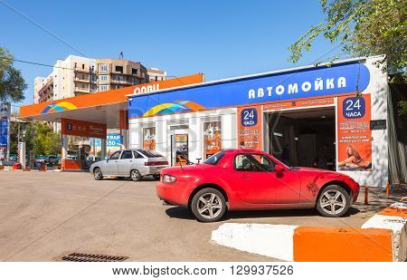 SAMARA RUSSIA - MAY 14 2016: Cars standing in line at the car wash near the gas station Olvi in sunny day